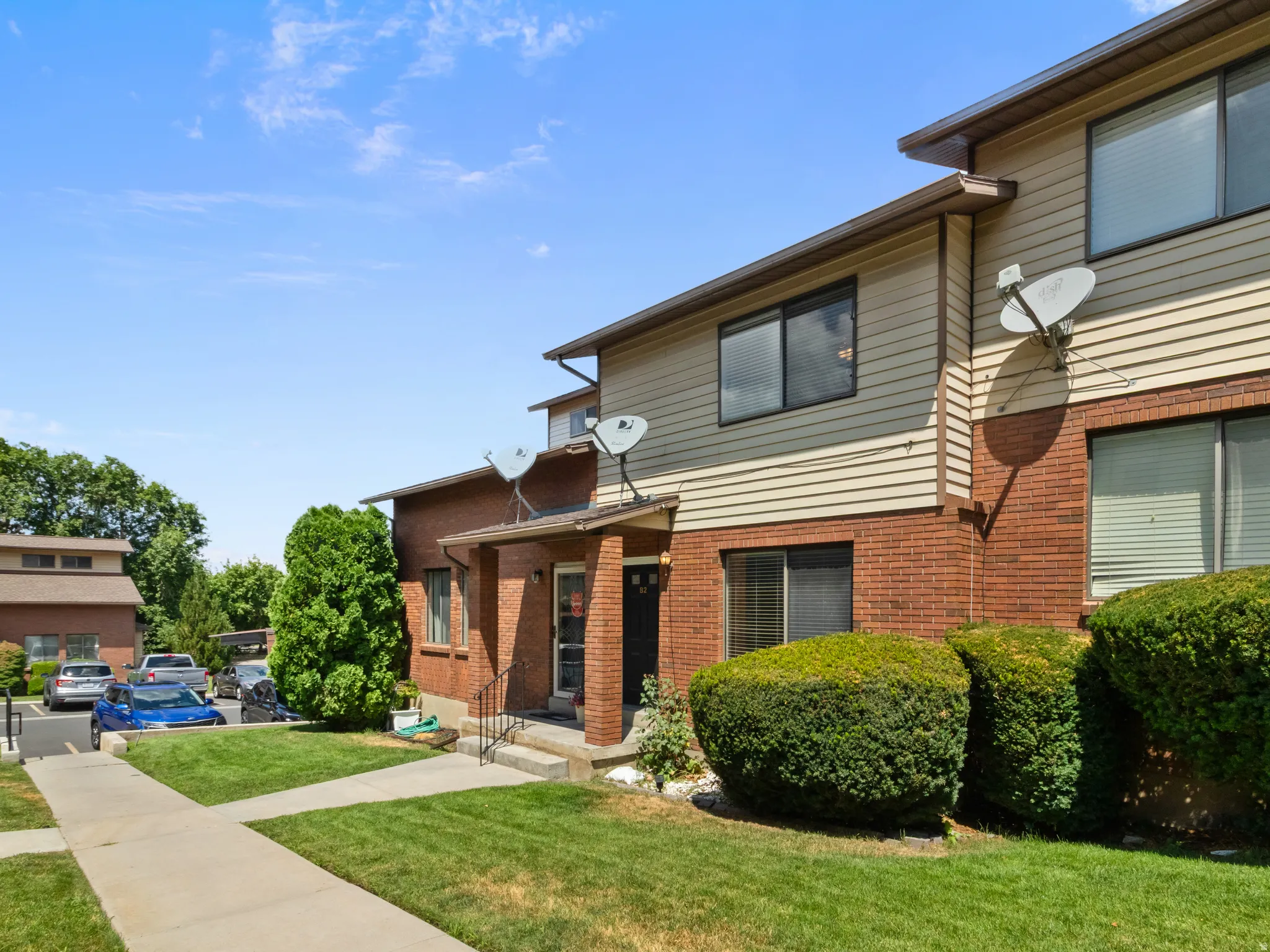 Brick and siding exterior featuring multiple windows and a covered entry