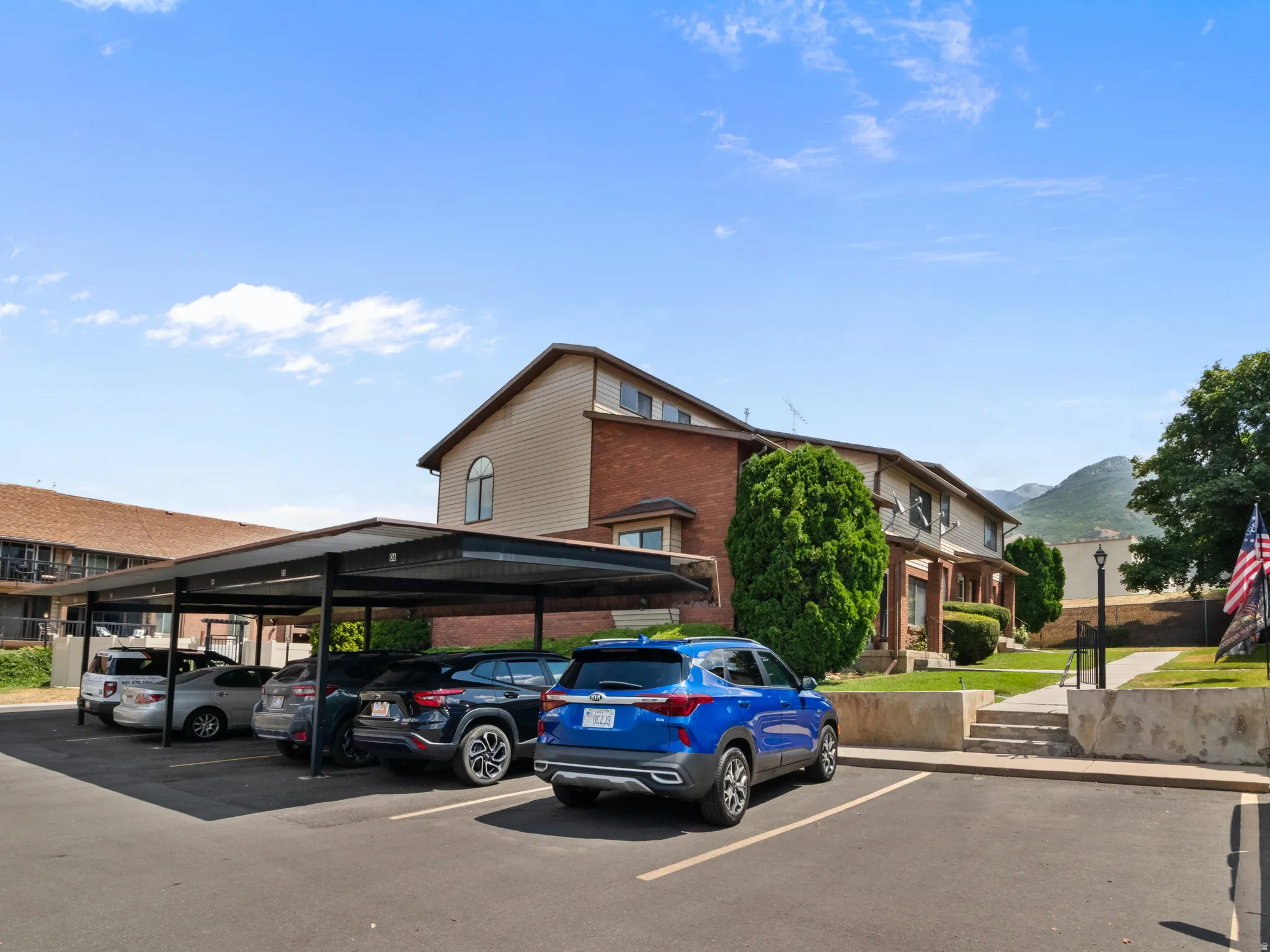 Carport parking structure providing covered vehicle accommodation