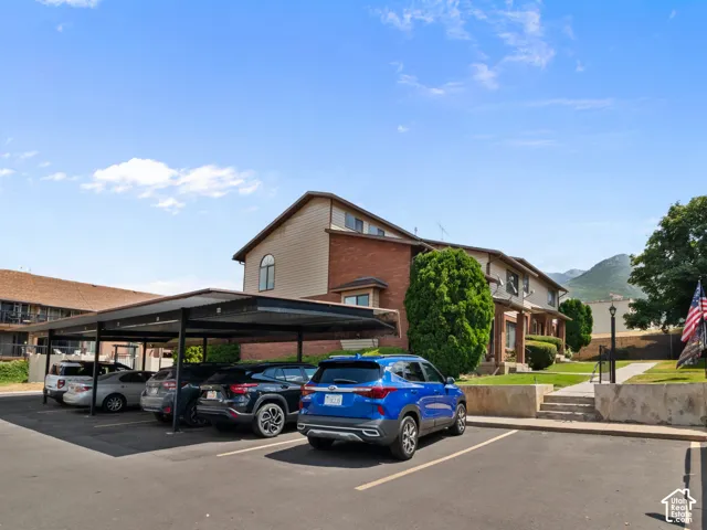 Carport parking structure providing covered vehicle accommodation