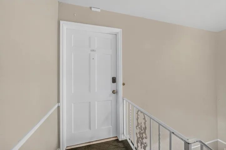 Entry door with paneled design and white trim