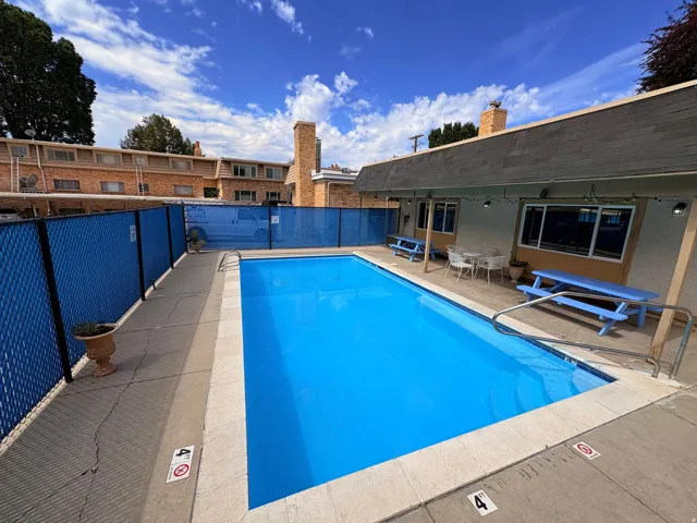 Rectangular swimming pool with a blue interior finish and concrete decking