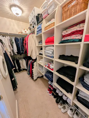 Custom closet system featuring built-in shelving, hanging rods, and integrated shoe storage