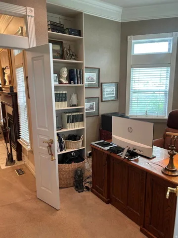 Custom built-in shelving with concealed door access