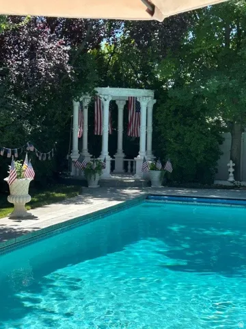 Inviting outdoor swimming pool with a surrounding concrete patio