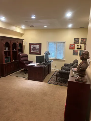 Spacious room featuring recessed lighting, a built-in wood-finish hutch, and a dedicated window with privacy sheers