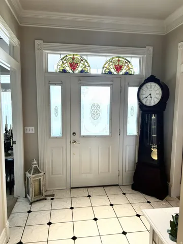 Double front entry doors with etched glass panels and sidelights