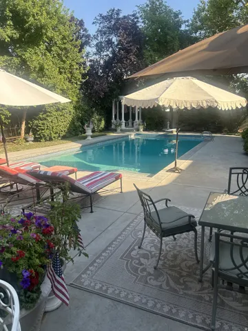 In-ground swimming pool with a surrounding concrete patio