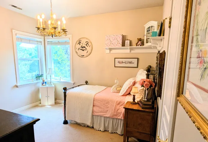 Corner window configuration, cased windows, and a classic chandelier fixture define this space