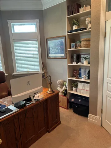 Built-in shelving unit with decorative crown molding and fluted trim