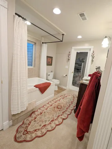 Soaking tub with a tiled surround, complemented by a privacy window