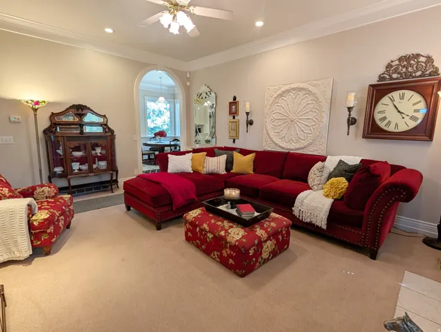 Carpeted living area featuring recessed lighting and a ceiling fan
