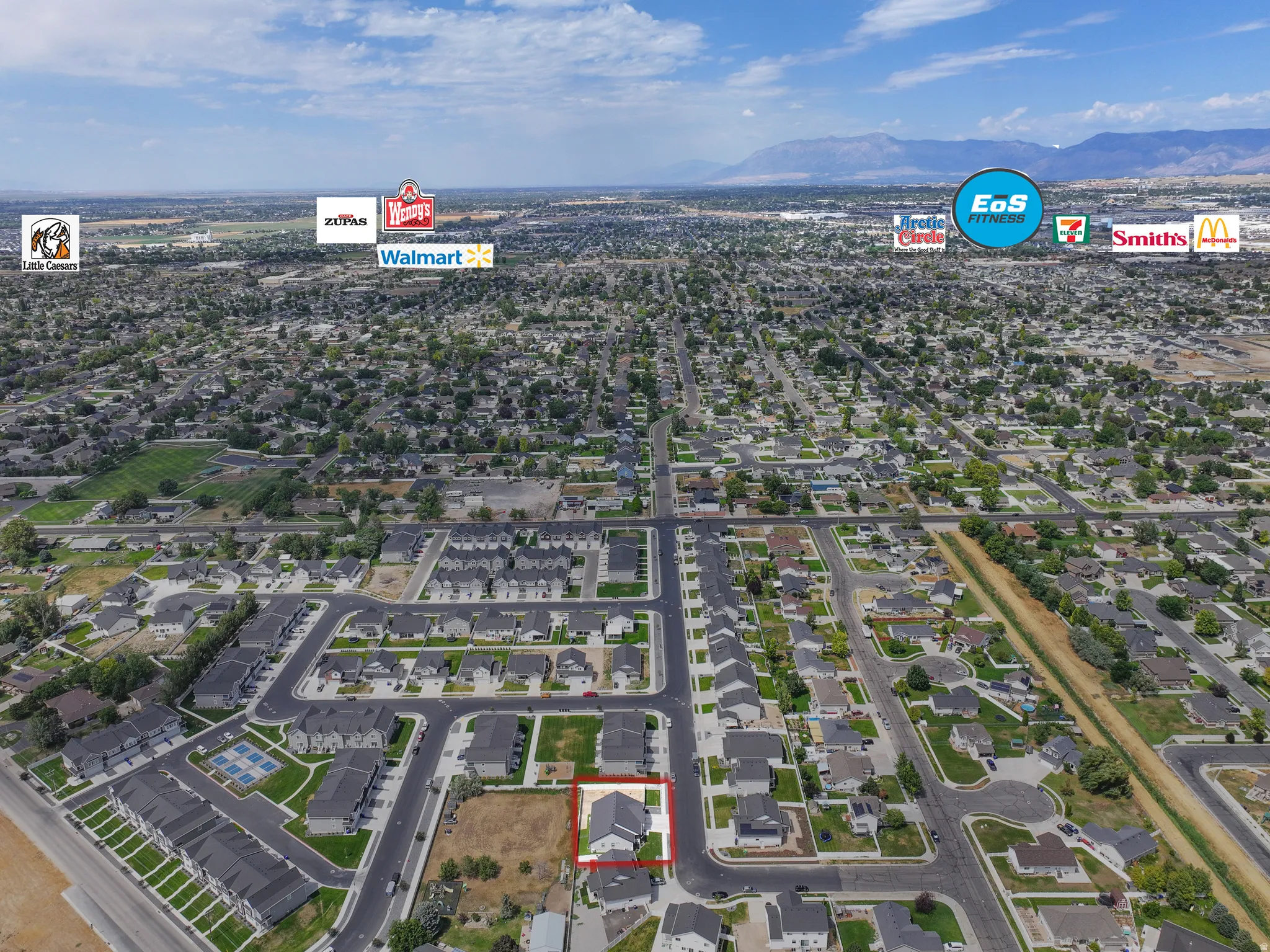 Aerial perspective showcasing a residential area with a prominent property outlined in red
