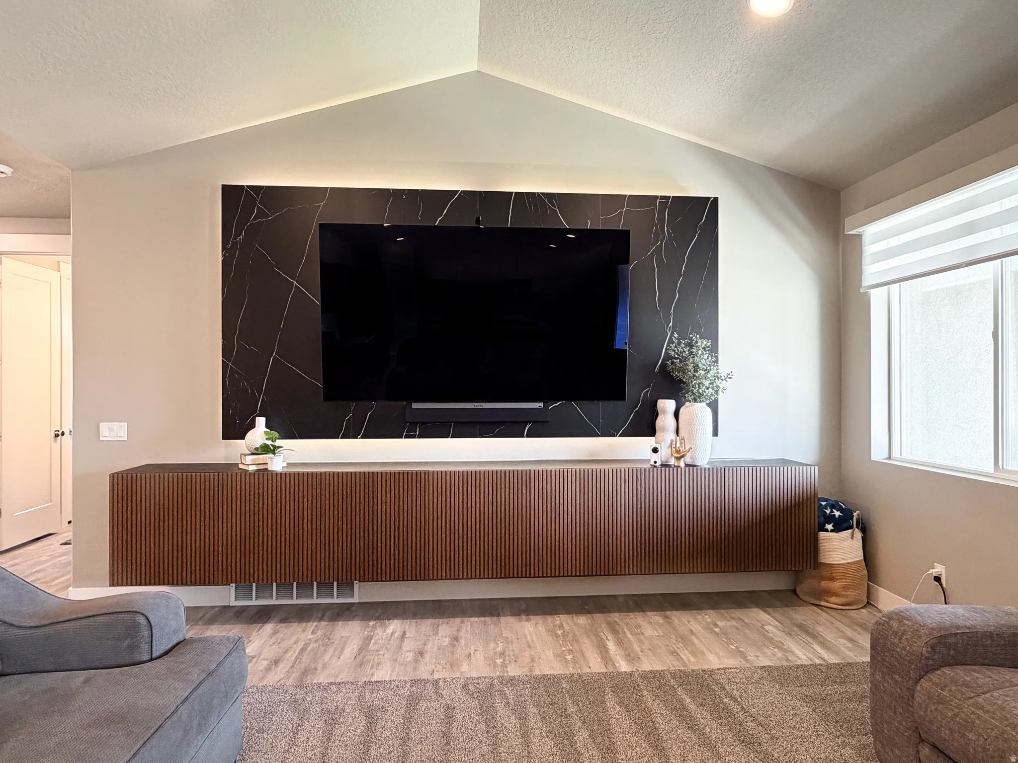 Accent wall featuring dark stone-look paneling with white veining