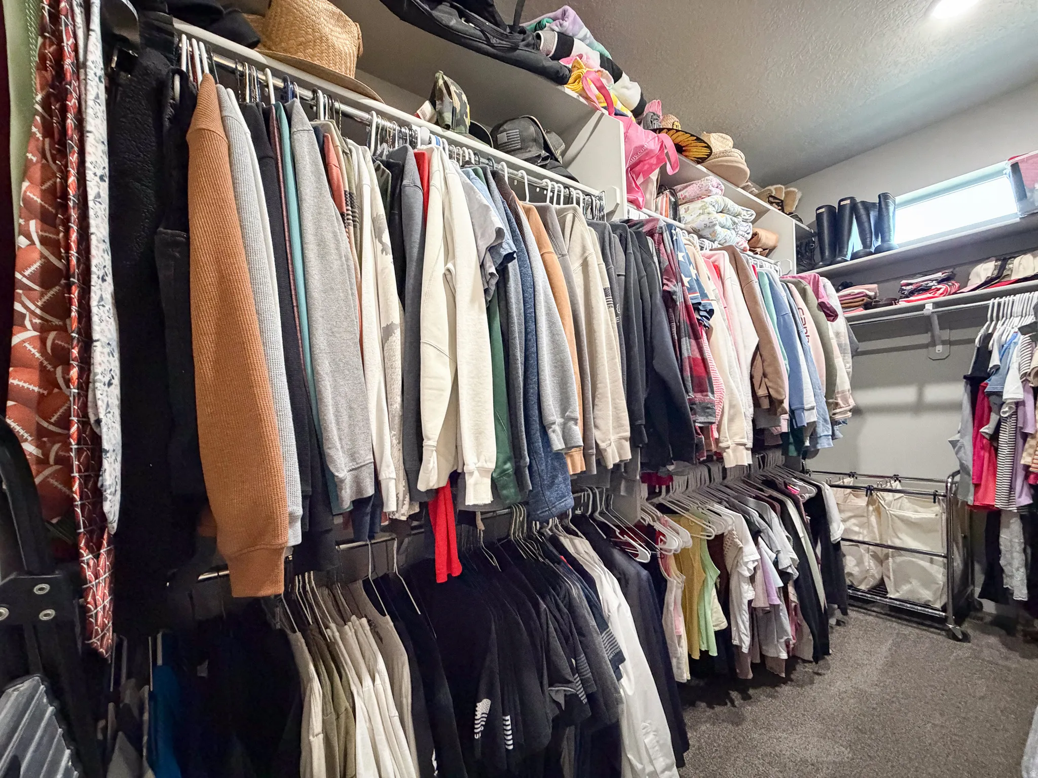 Spacious walk-in closet featuring multiple shelving units and clothing rods for extensive storage