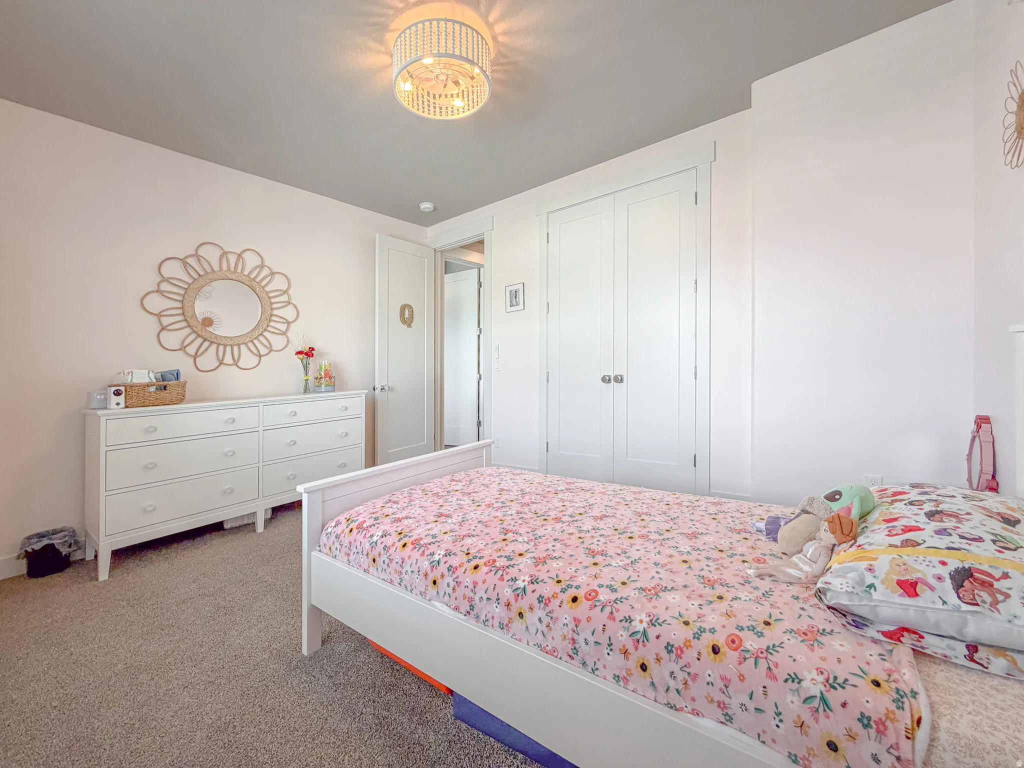 Carpeted room featuring a ceiling-mounted light fixture, white walls, and a light gray ceiling