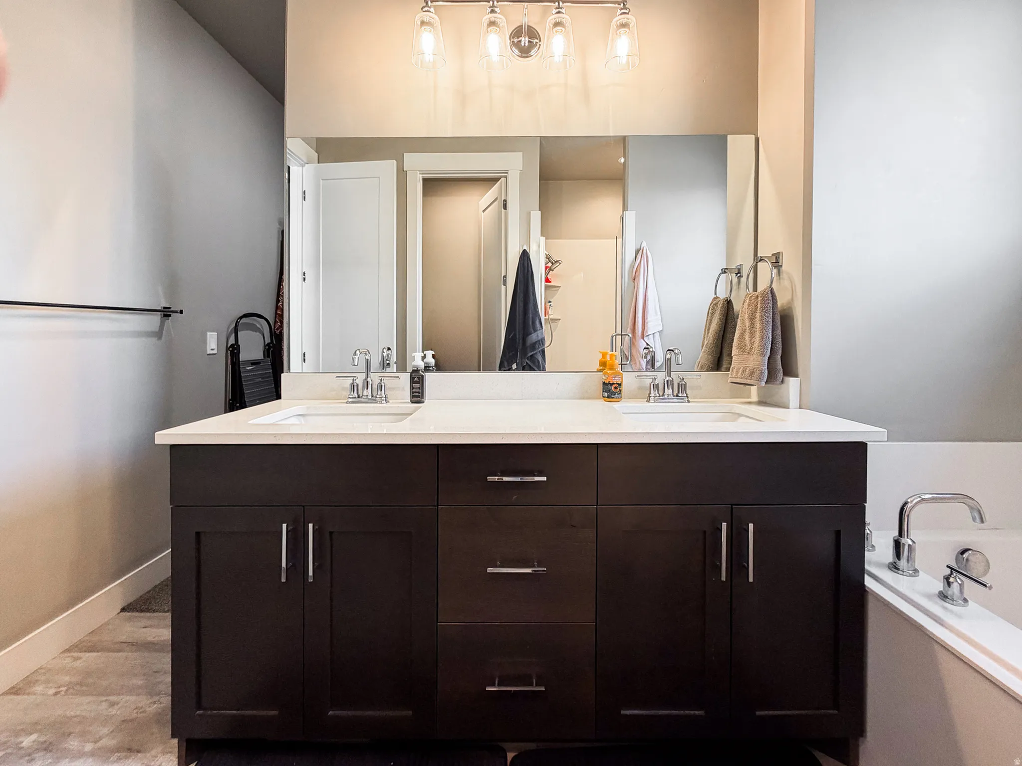 Double vanity with a light-toned countertop, dual rectangular sinks, and chrome faucets