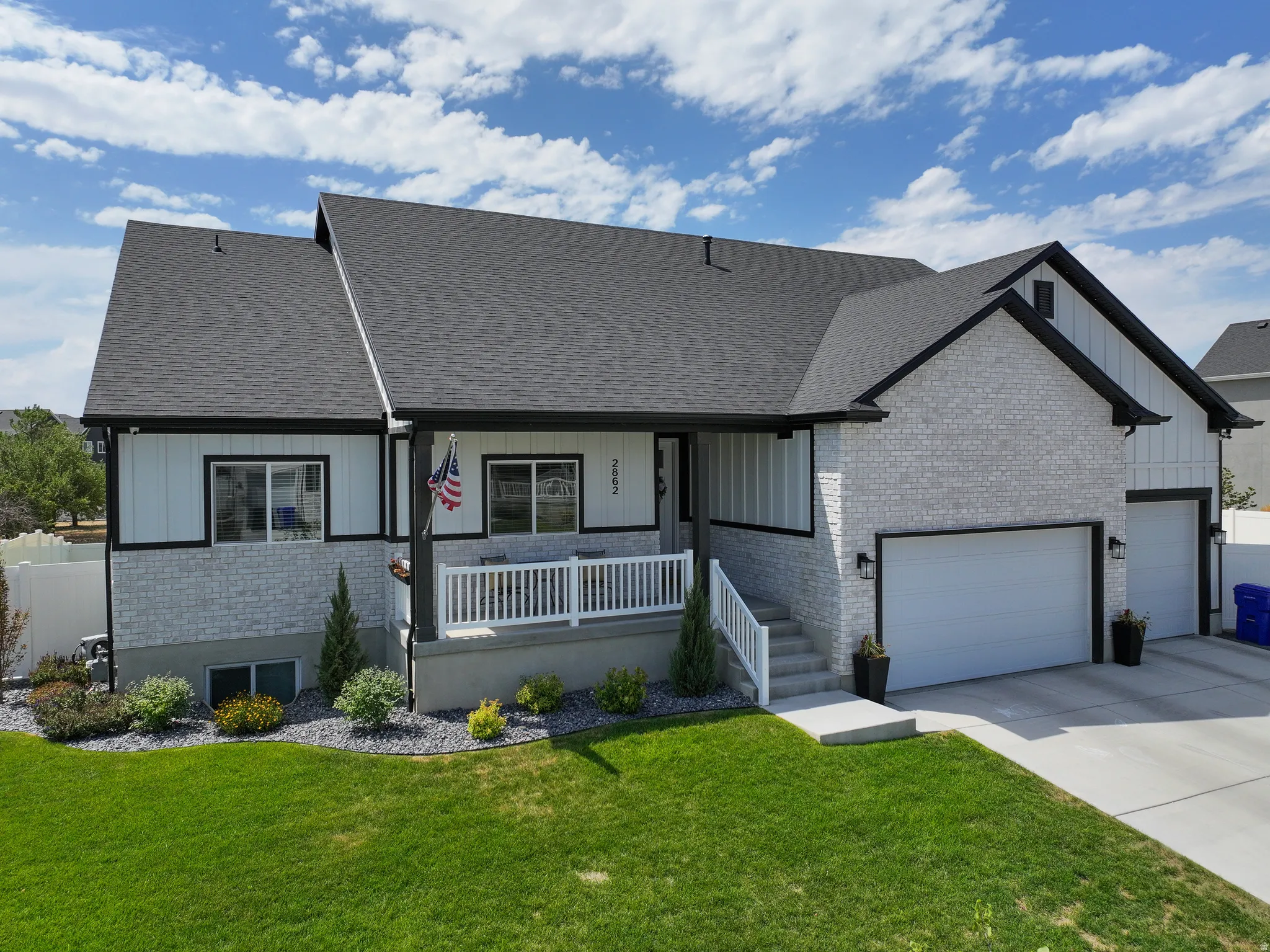 Modern exterior featuring white brick and vertical siding