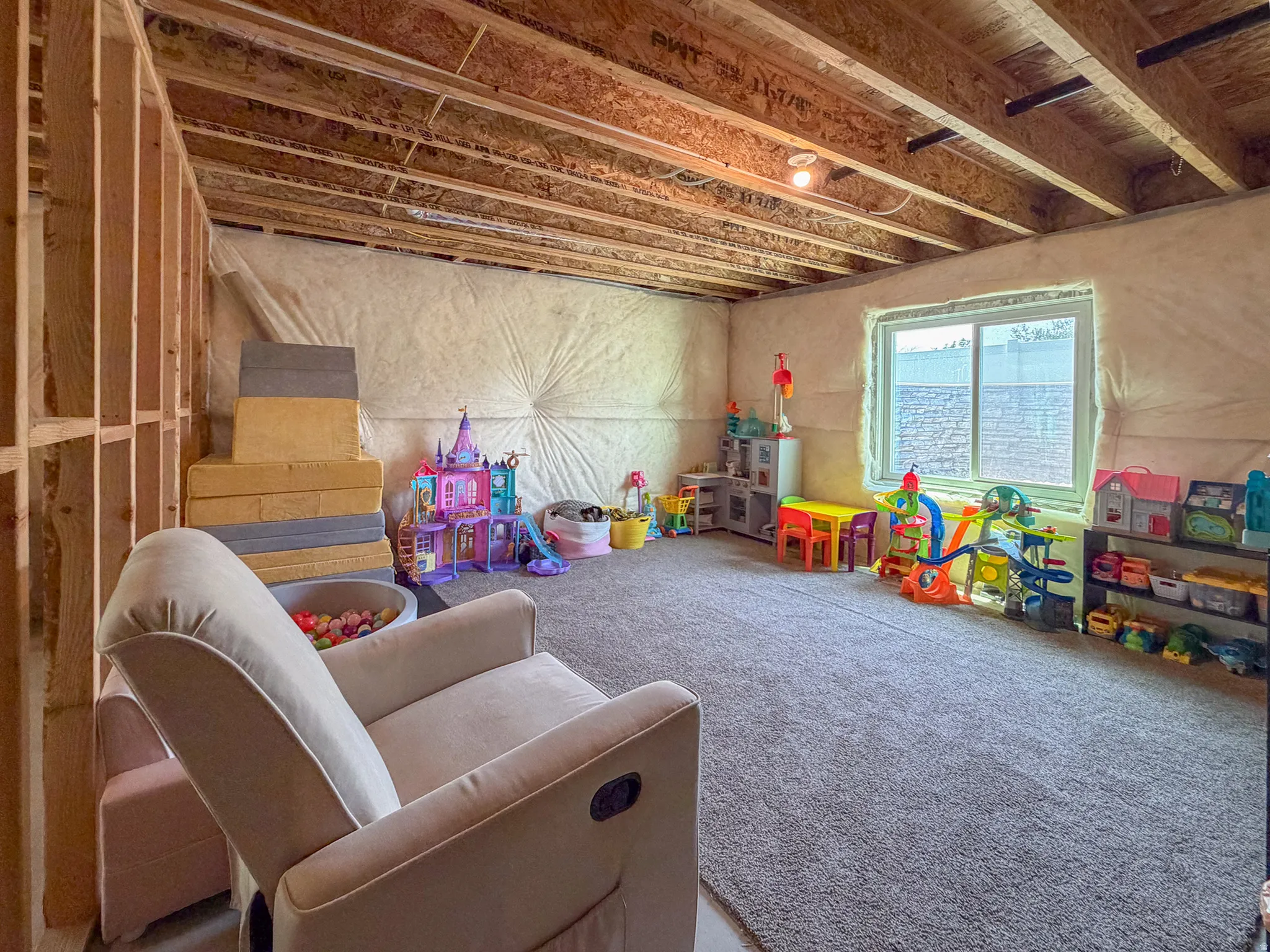 Lower level featuring exposed ceiling joists and wood framing