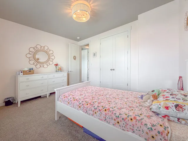 Carpeted room featuring a ceiling-mounted light fixture, white walls, and a light gray ceiling