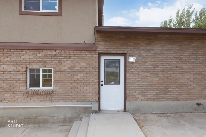 Exterior brick facade with a stucco upper level