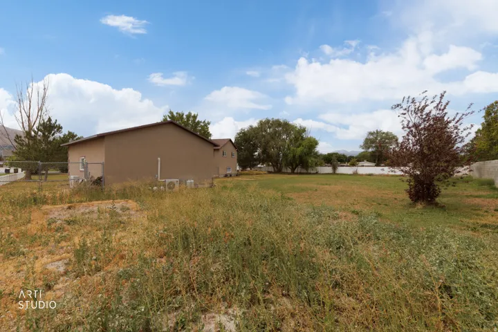 Expansive open lot with a tan-colored exterior building in the background