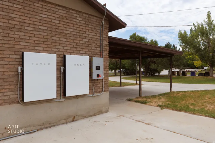 Brick exterior featuring two Tesla Powerwall units and an integrated inverter