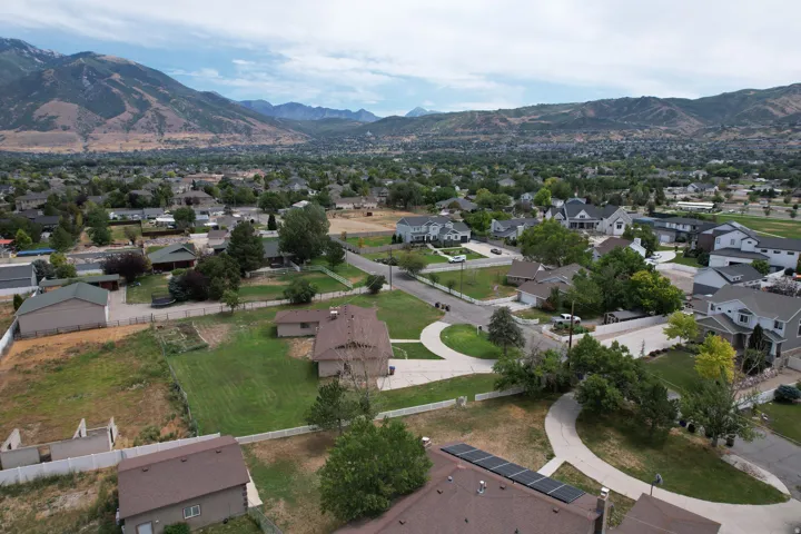 Expansive neighborhood featuring a variety of residential properties, mature trees, and mountain backdrops