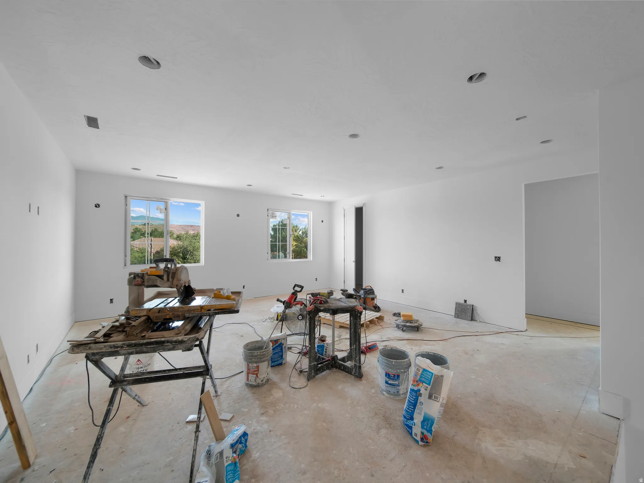 Spacious interior featuring multiple windows, recessed ceiling lighting, and a neutral wall palette
