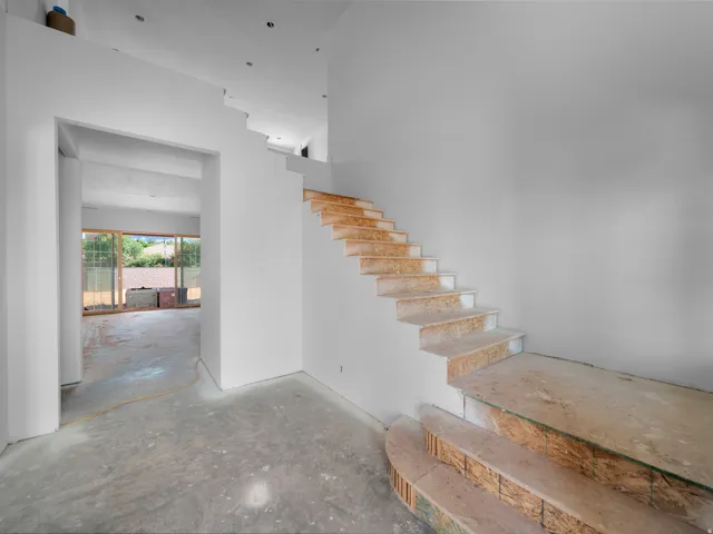 Multi-level interior featuring a contemporary staircase with an open riser design and a curved bottom step