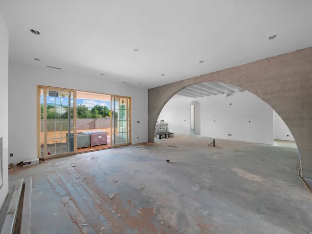 Expansive interior space featuring a large archway and recessed lighting