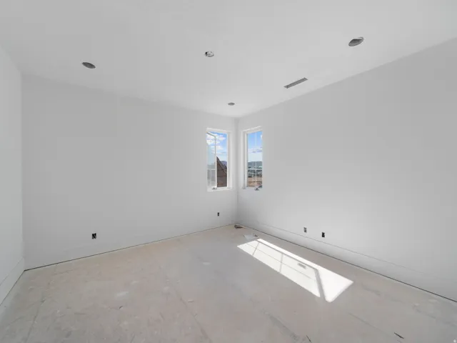 Room featuring multiple windows, recessed ceiling lighting, and baseboard trim