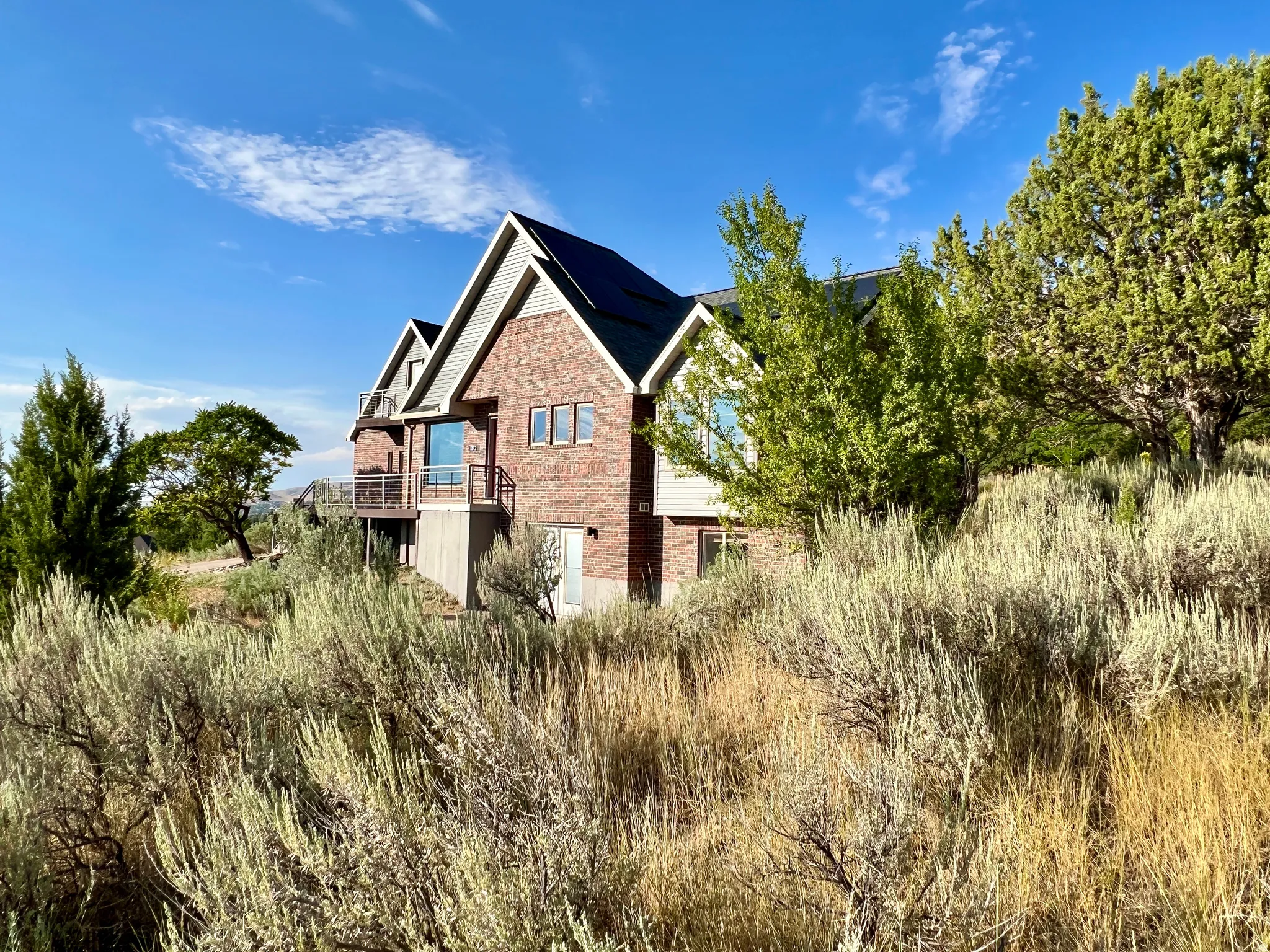 Brick and siding exterior with multiple gables and solar panels