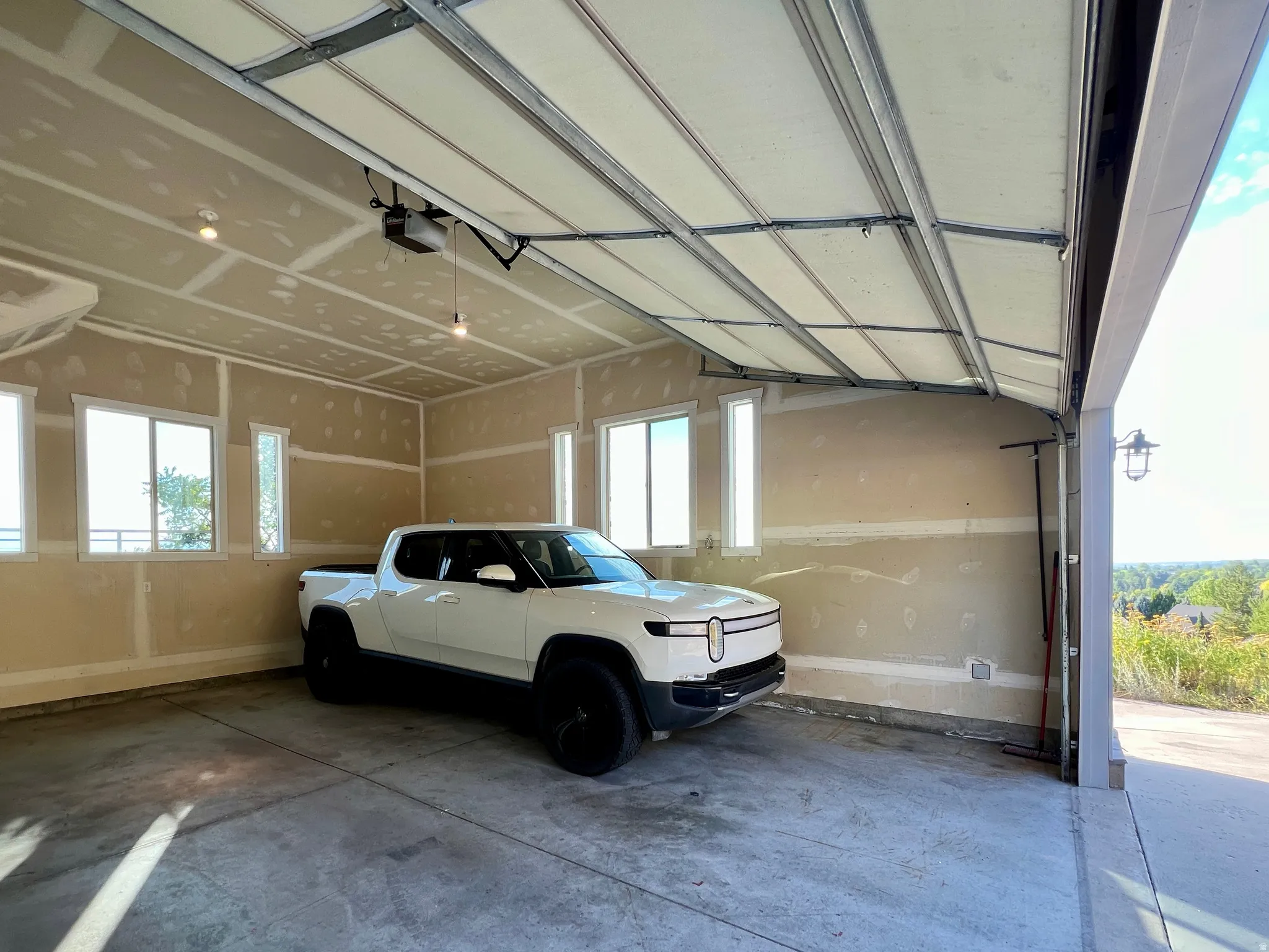 Spacious garage with an automatic overhead door