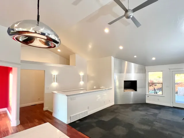 Vaulted ceiling with recessed lighting and a ceiling fan