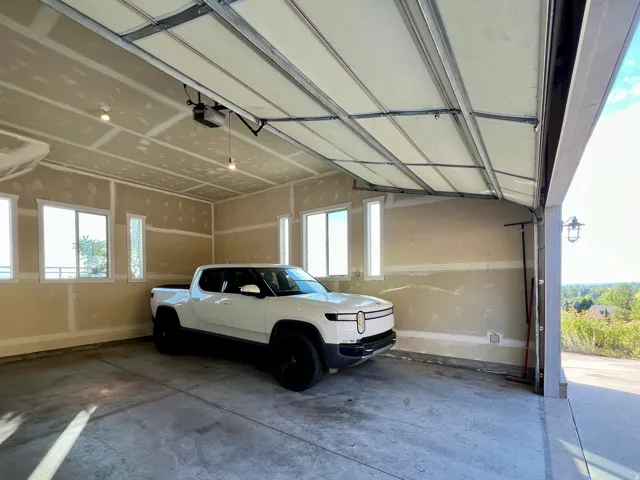 Spacious garage with an automatic overhead door