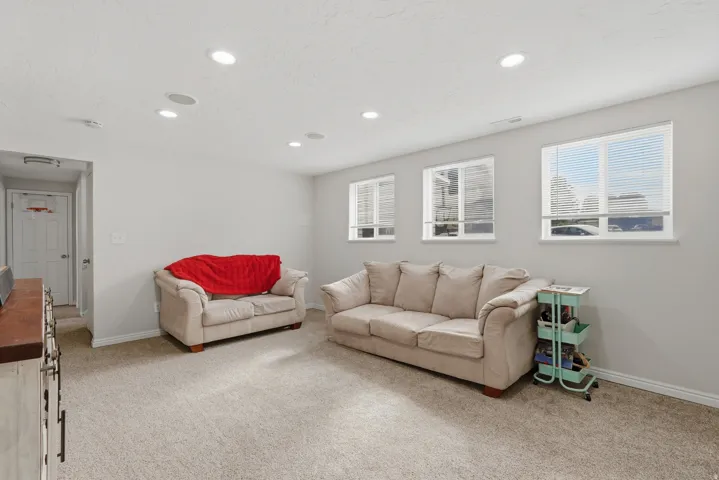 Spacious room featuring neutral carpeting and light gray walls