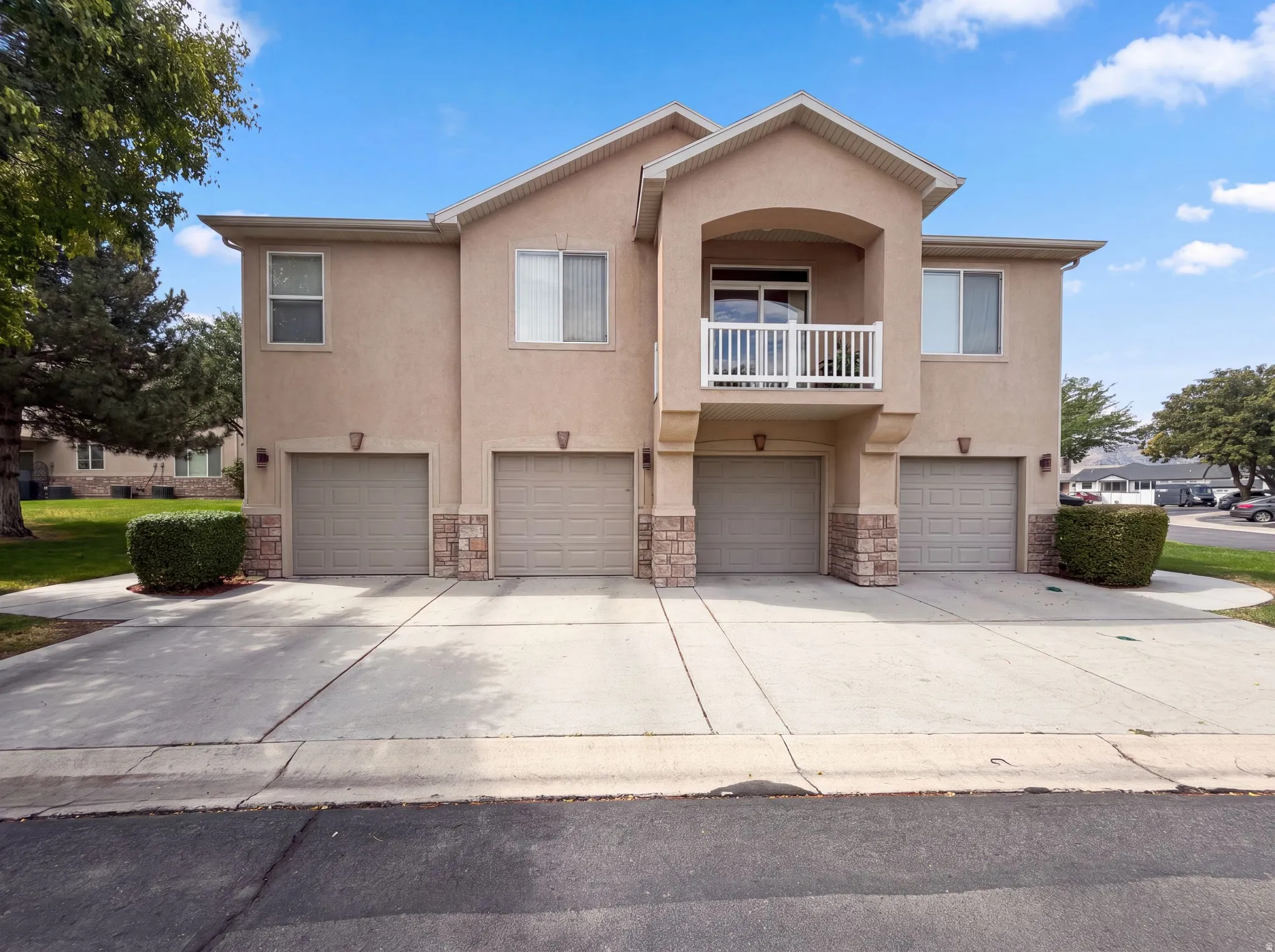 Multi-unit property featuring a stucco exterior with stone accents