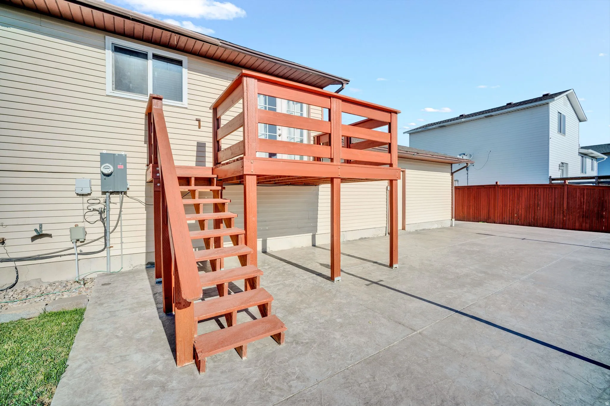 Upper-level deck with wood railing and stairs