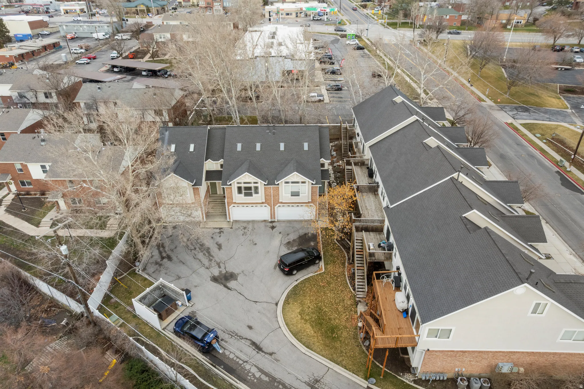 Townhome-style building with multiple units, each featuring a private garage and individual entrance
