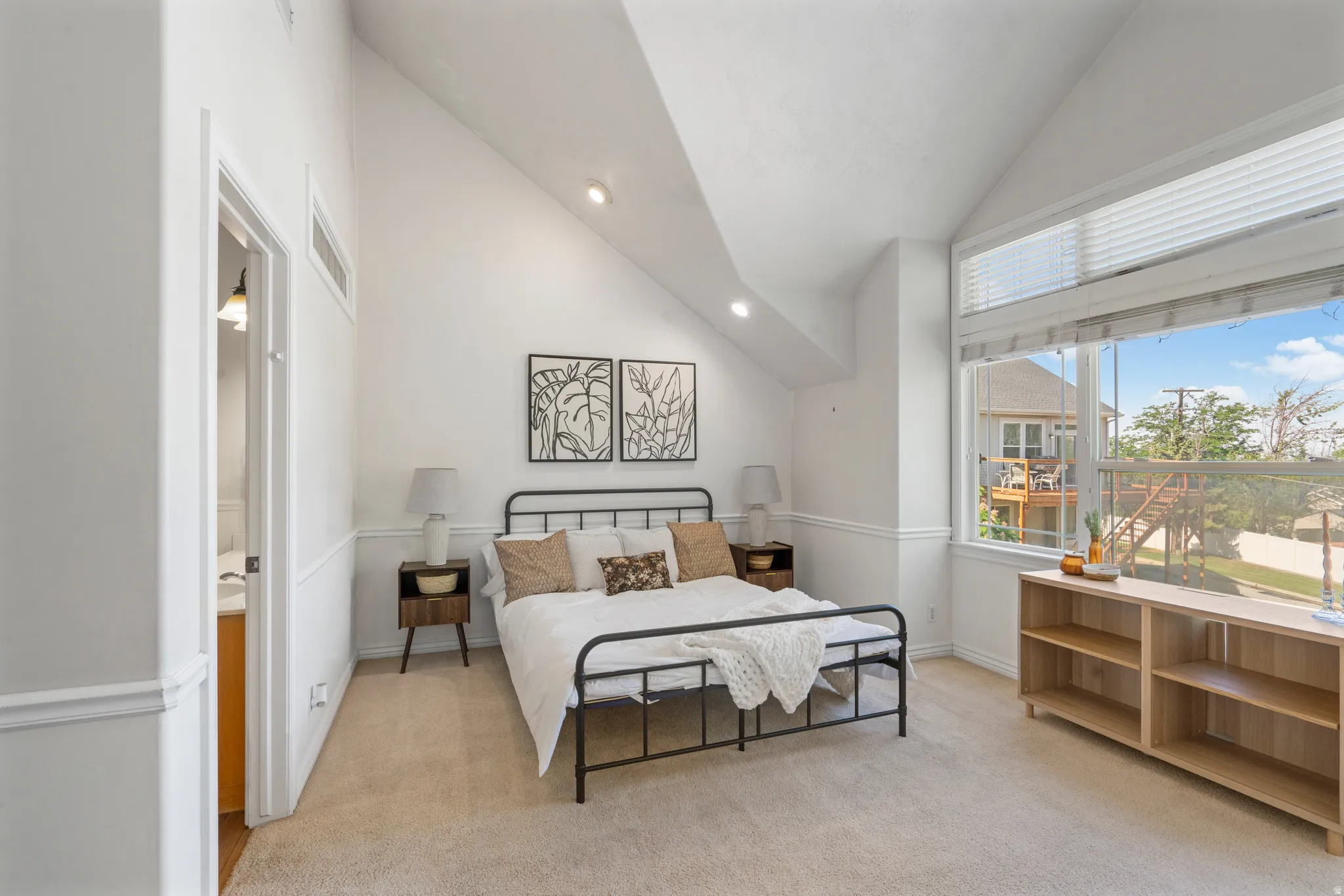 Carpeted room featuring a vaulted ceiling with recessed lighting