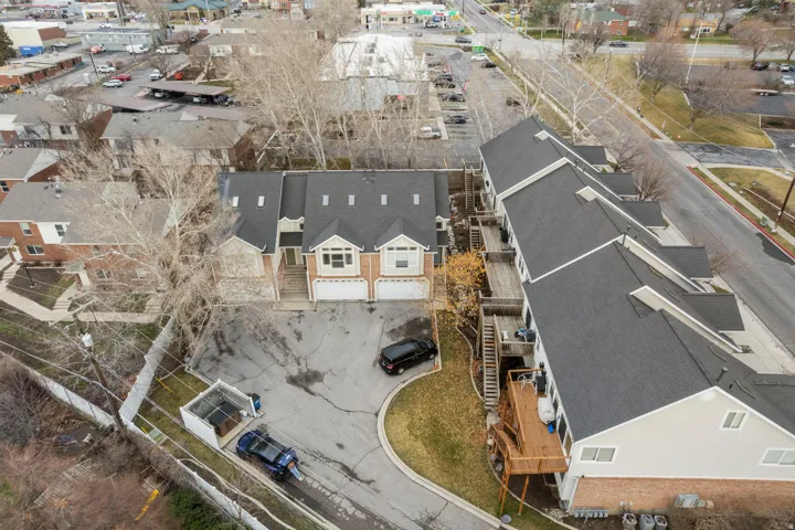 Townhome-style building with multiple units, each featuring a private garage and individual entrance