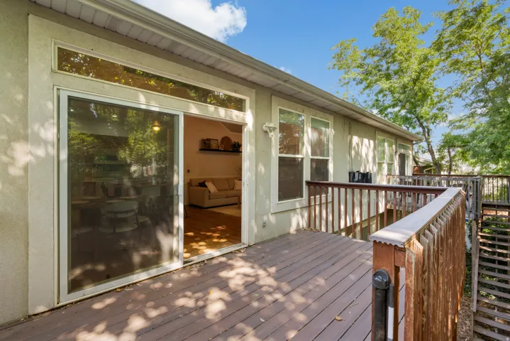 Multi-level wood deck featuring wood railings and a staircase