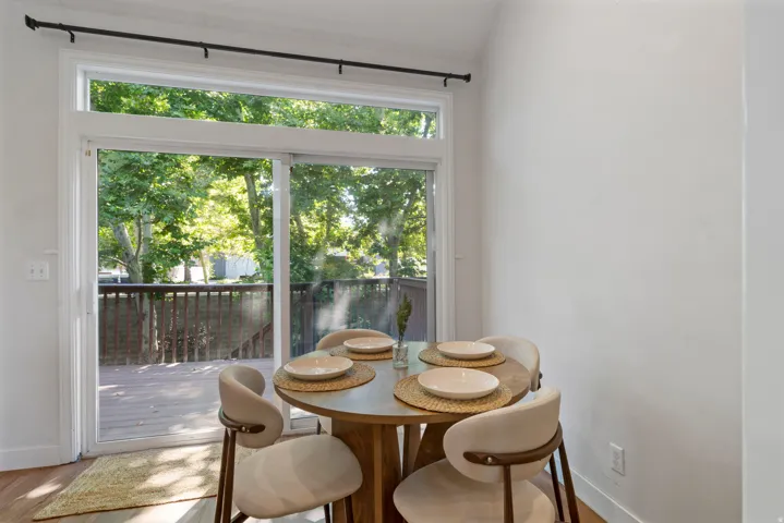 Sliding glass doors opening to an exterior wooden deck