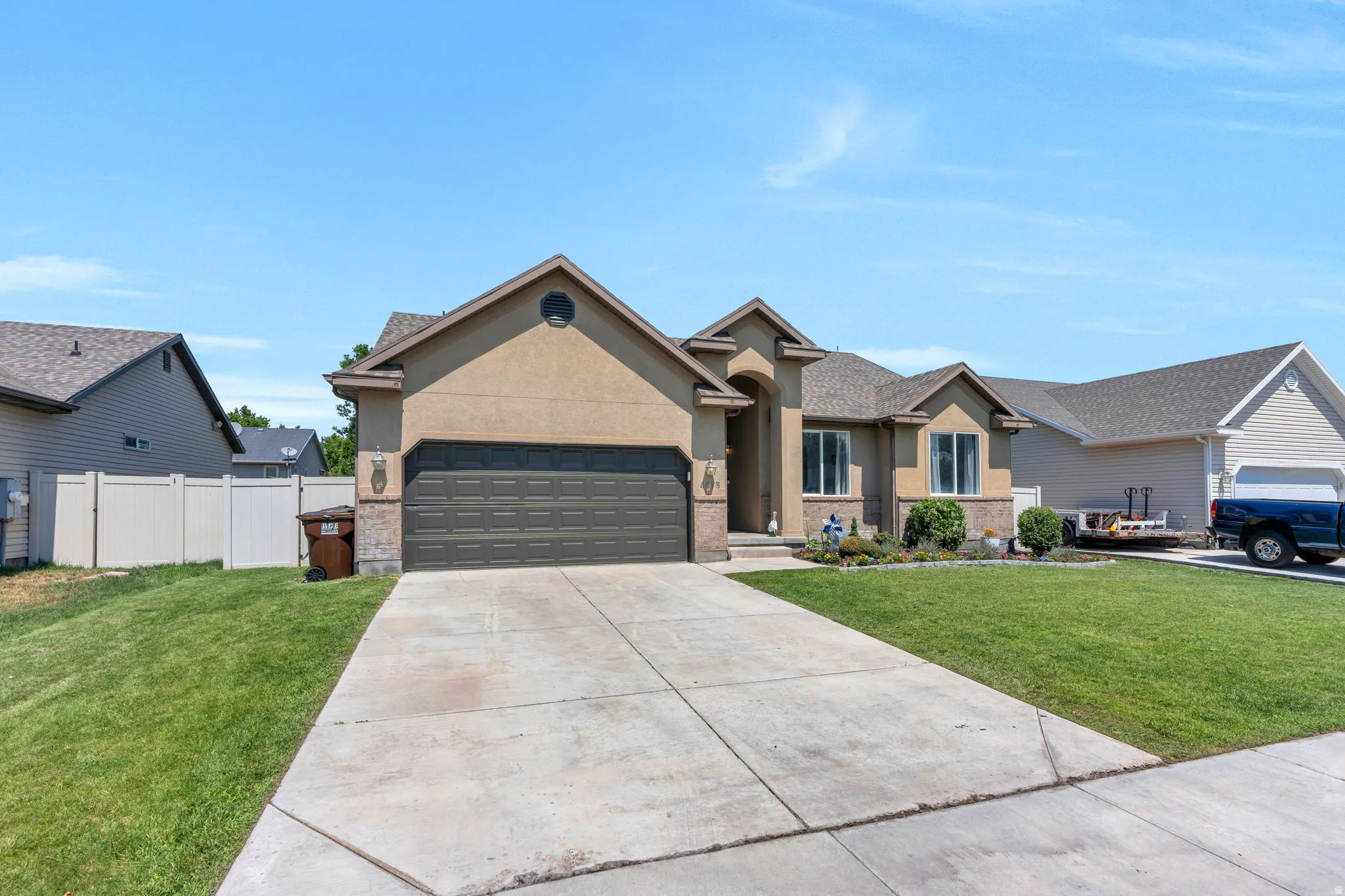 Stucco exterior with stone accents and a gabled roofline