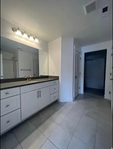 White vanity with extensive countertop space and integrated sink