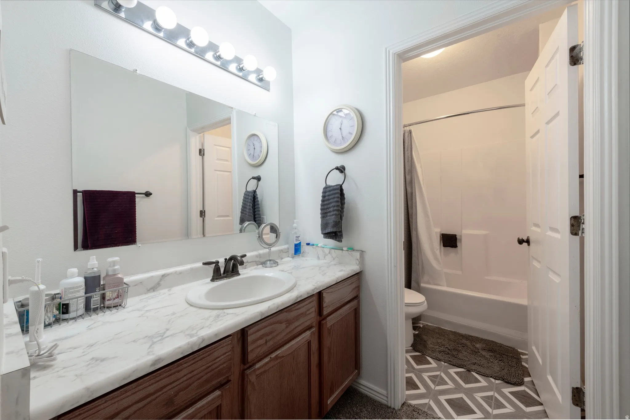 Bathroom vanity featuring an integrated sink, bronze-finish faucet, and a spacious countertop