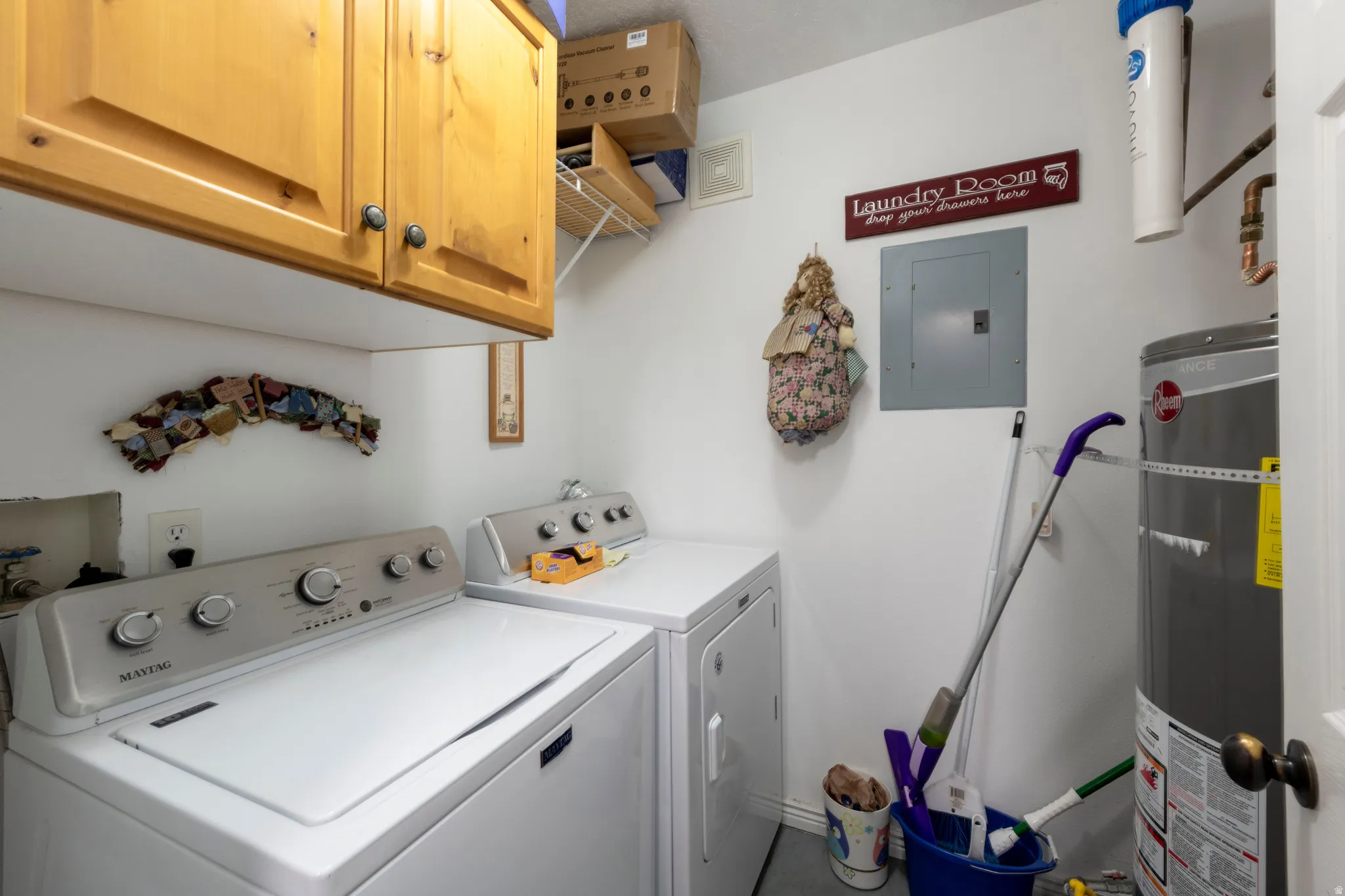 Dedicated laundry space featuring upper wood cabinetry and convenient appliance hookups