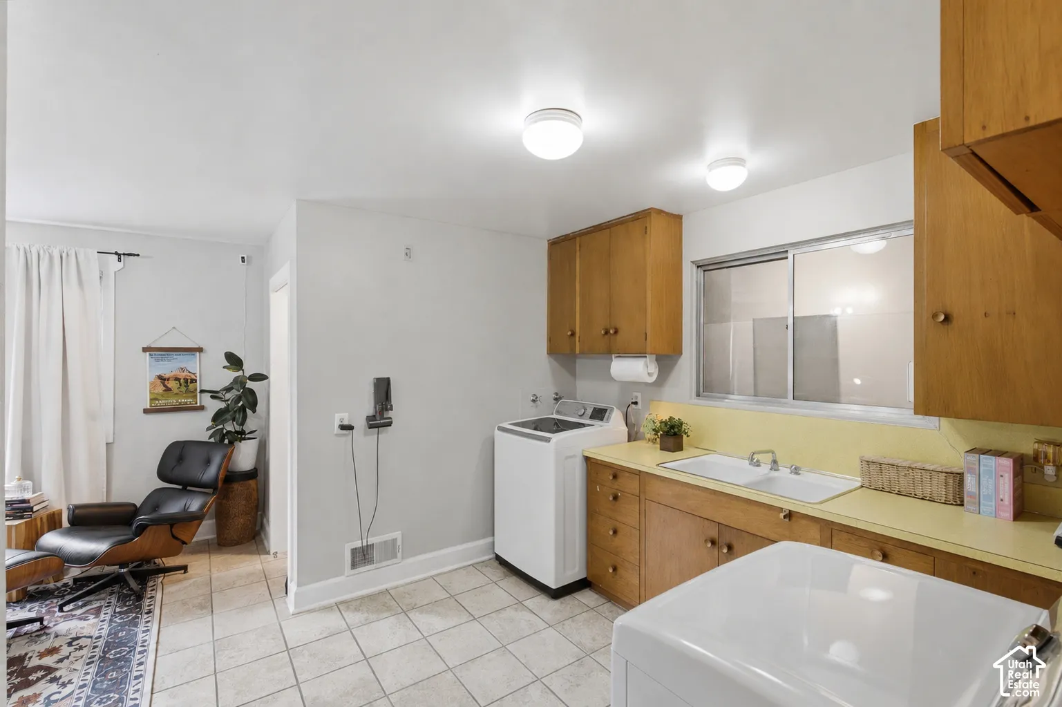 Laundry room includes countertop and double basin sink.