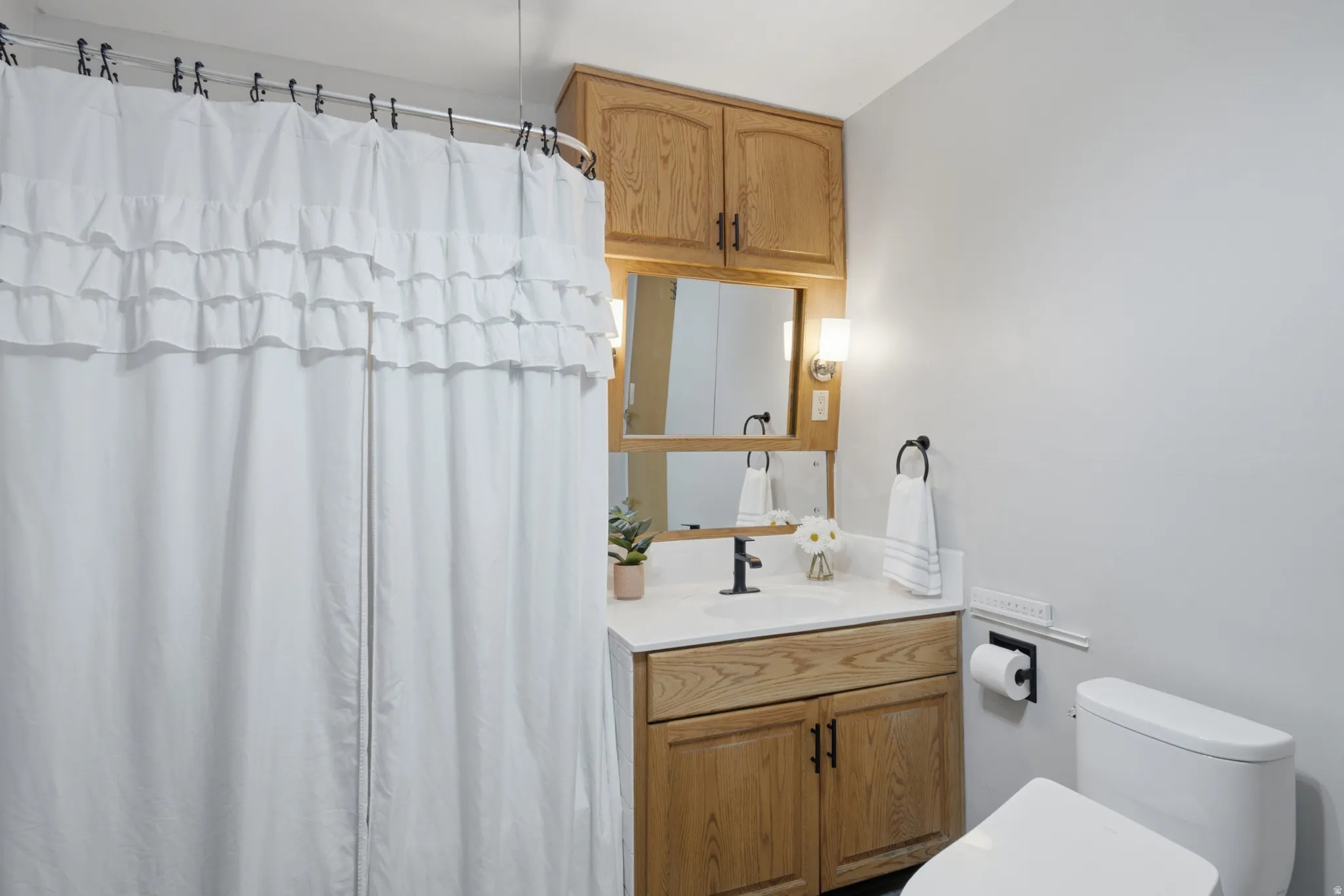 Bathroom featuring a light wood vanity with a white countertop and a rectangular undermount sink