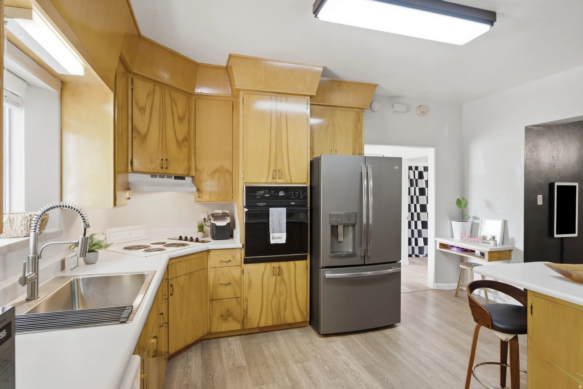Wood cabinets throughout kitchen offer plenty of kitchen storage space.